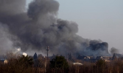 Una columna de humo se eleva sobre un edificio cercano al aeropuerto de Leópolis, en Ucrania.