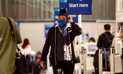 Una mujer con barbijo camina en el aeropuerto de Delaware, Estados Unidos. EFE
