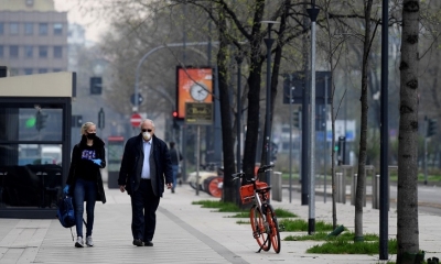 Dos personas con mascarilla en una calle de Milán (Lombardía, Italia), el 20 de marzo de 2020.