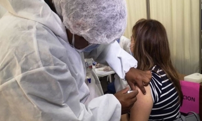 Personal de salud aplica la vacuna a una mujer. 